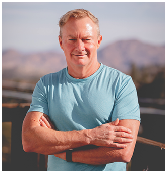 A man wearing a blue shirt and brown pants. Description generated by AI