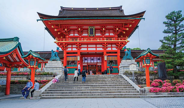 A large building with a red roof and green trim. Description generated by AI