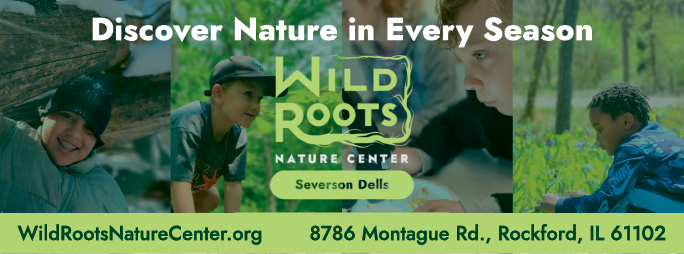 A green and white sign advertising the Wild Roots Nature Center. Description generated by AI