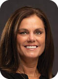 A woman with brown hair and a smile on her face. Description generated by AI