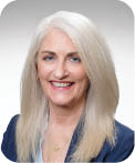 A woman wearing a blue shirt and a blue jacket. Description generated by AI