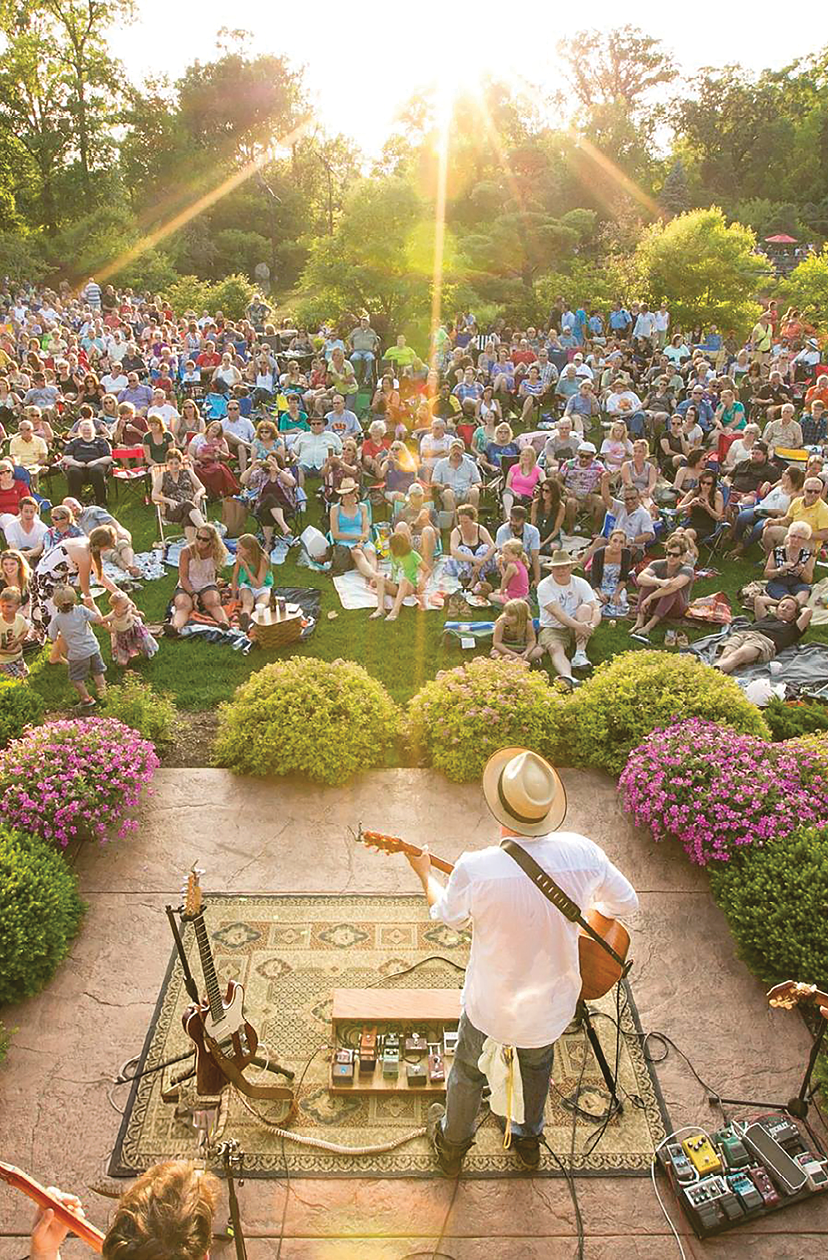 A man is playing guitar in front of a crowd of people. Description generated by AI