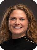 A woman with curly hair wearing a black shirt. Description generated by AI