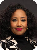 A woman wearing a black and white jacket. Description generated by AI