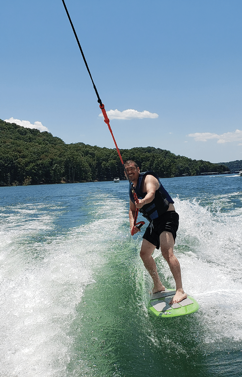 A man is water skiing on a lake, holding onto a rope. AI generated content