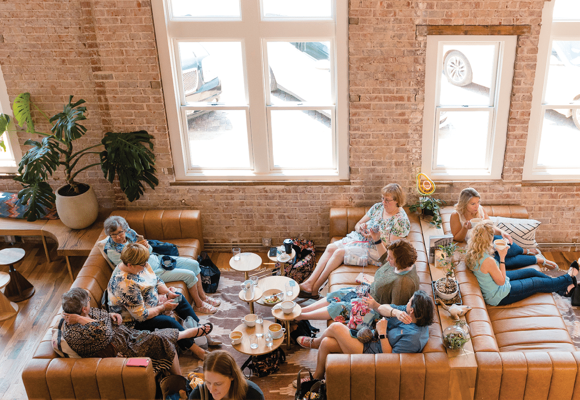 A group of people are sitting in a restaurant. Description generated by AI