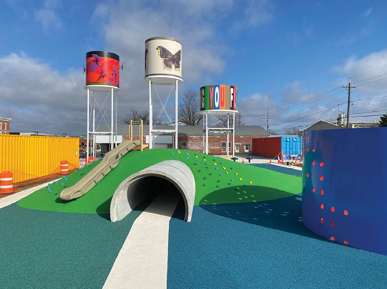 A playground with a slide and a tunnel. Description generated by AI