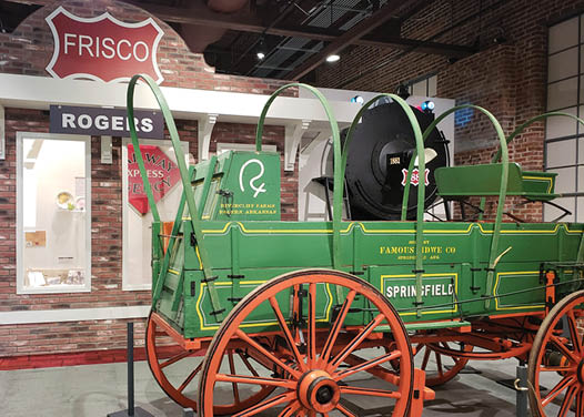 A green wagon with a black horse head is on display in a museum. AI generated content