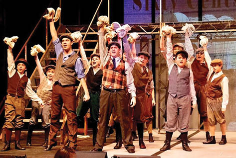 A group of men are on stage holding stuffed animals. Description generated by AI