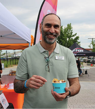 A man in a green shirt is holding a blue container. AI generated content