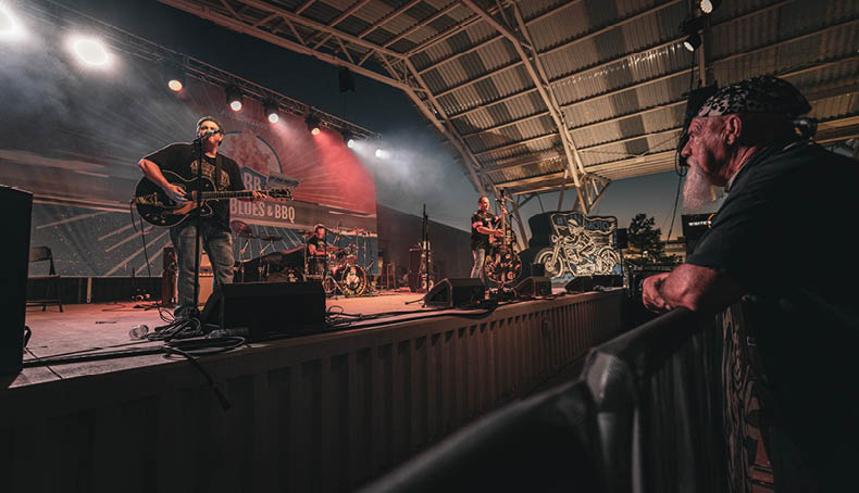A man watches a band perform on stage. AI generated content