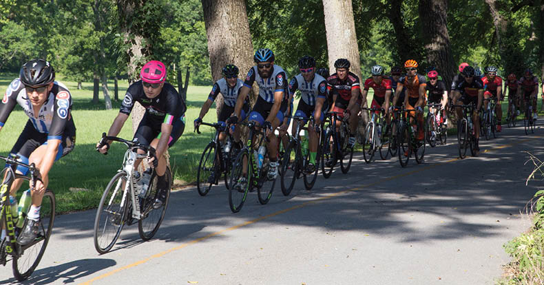 A group of people riding bikes down a road. AI generated content