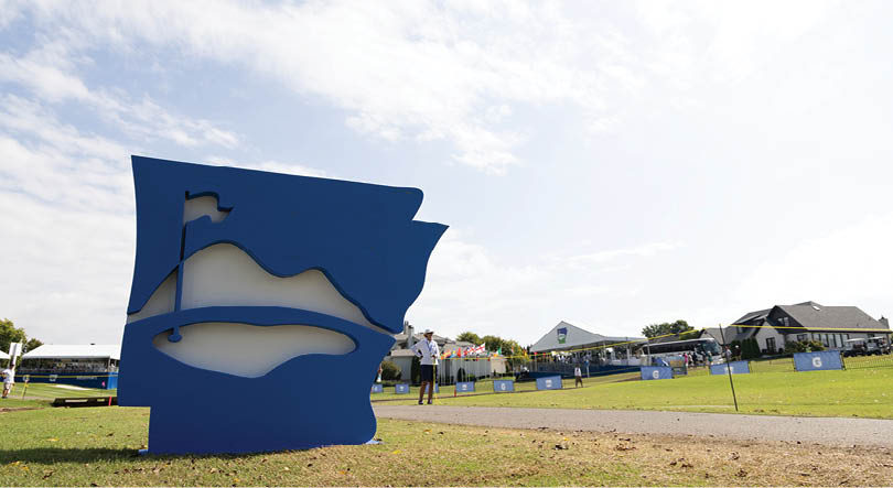 A blue sculpture of a state shape is displayed in a field. AI generated content