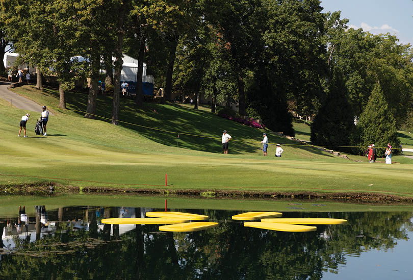 A group of people are playing golf on a course near a body of water. AI generated content