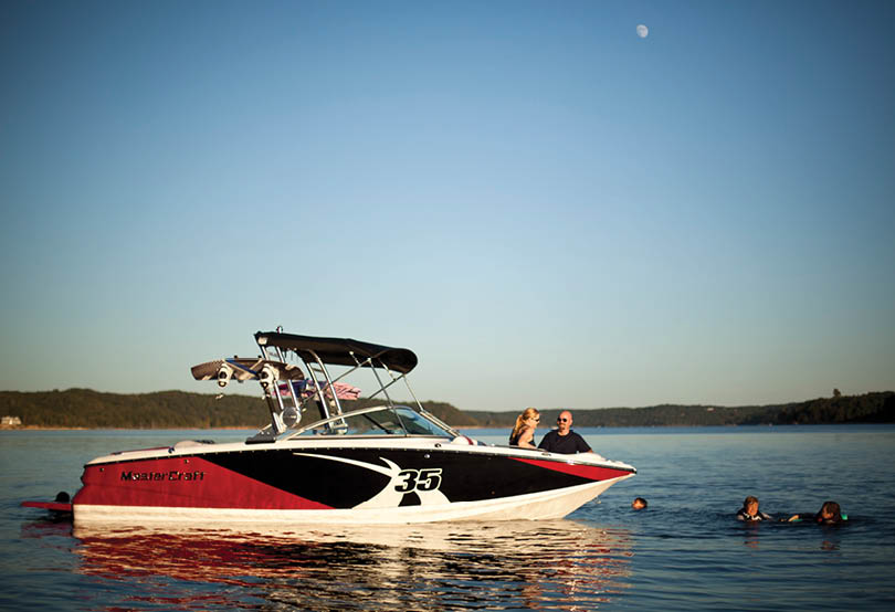 A group of people are in the water, enjoying a day on a speed boat. AI generated content