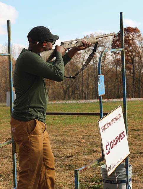 A man is shooting a rifle at a target. Description generated by AI