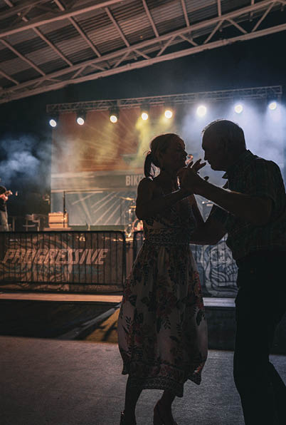 A man and woman are dancing on a stage. Description generated by AI