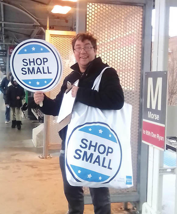 A man holding two signs that say “shop small" is standing on a sidewalk. AI generated content