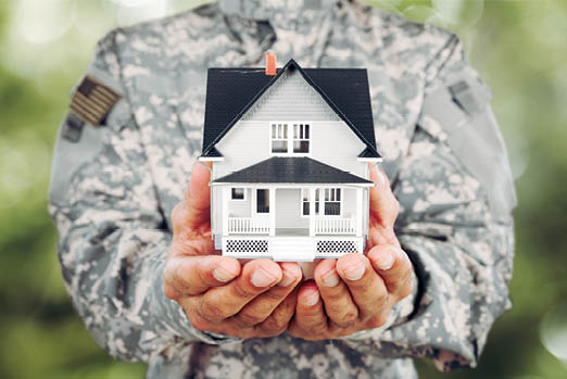 Soldier Holding a Model of House