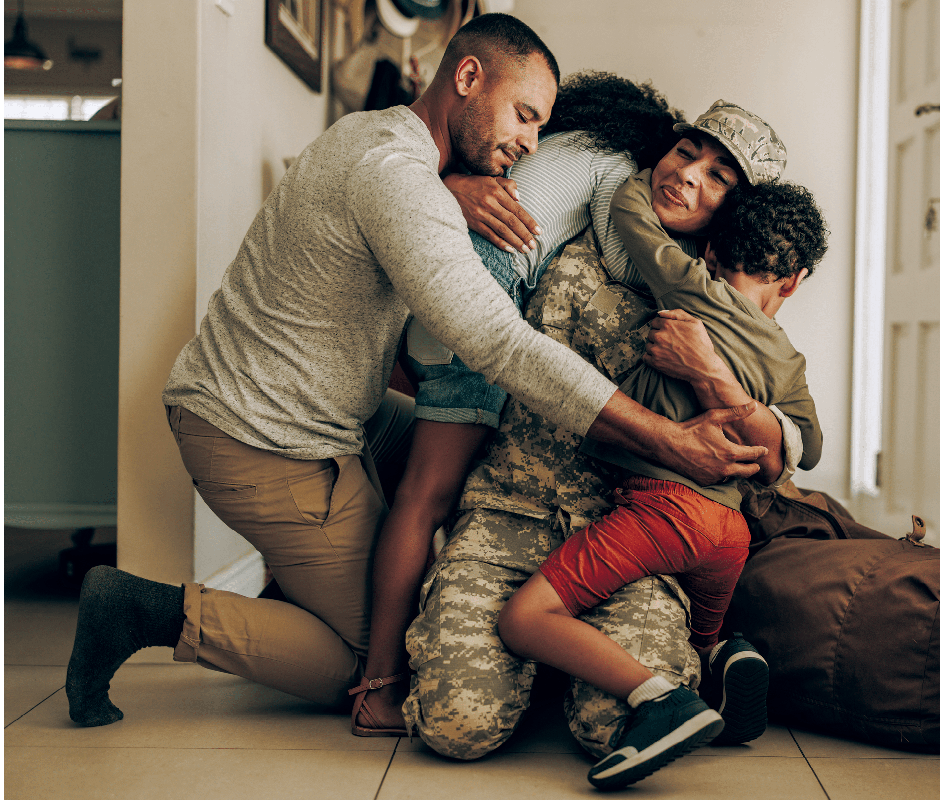 Happy military homecoming. Female soldier reuniting with her husband and children after serving in the army. Cheerful servicewoman embracing her family after returning home from deployment.