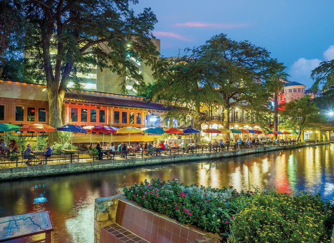 River walk in San Antonio city downtown skyline cityscape of Texas USA at sunset