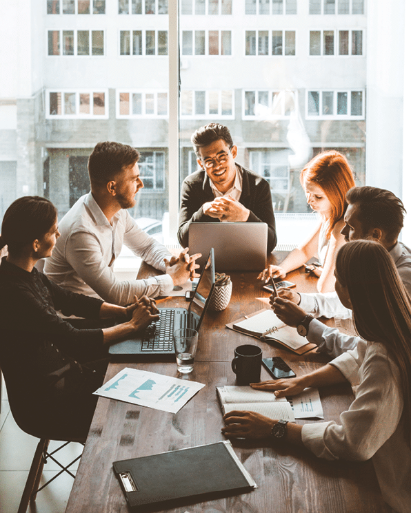 A team of young businessmen working and communicating together in an office. Corporate businessteam and manager in a meeting