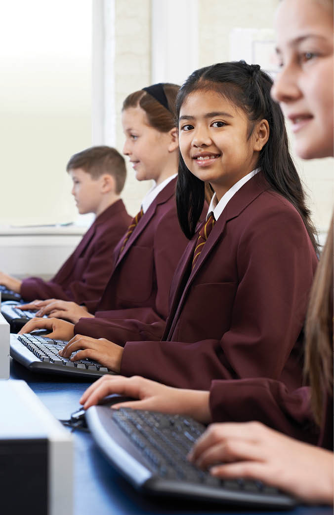 Pupils Wearing School Uniform In Computer Class