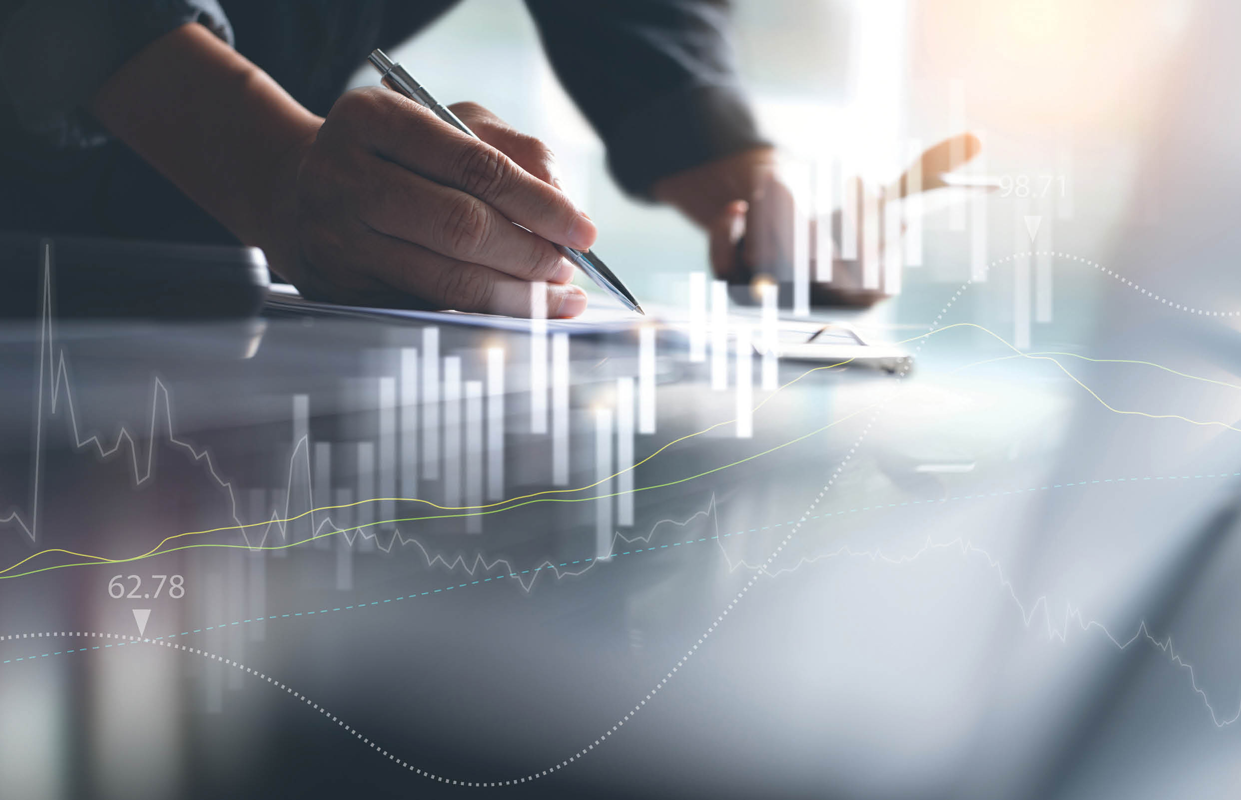 Business finance and investment background, businessman or finance analyst working in office with trading graph marketing report on virtual screen