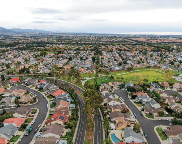 Aerial view of urban sprawl. Suburban packed homes neighborhood with road. Vast subdivision in Irvine, California, USA