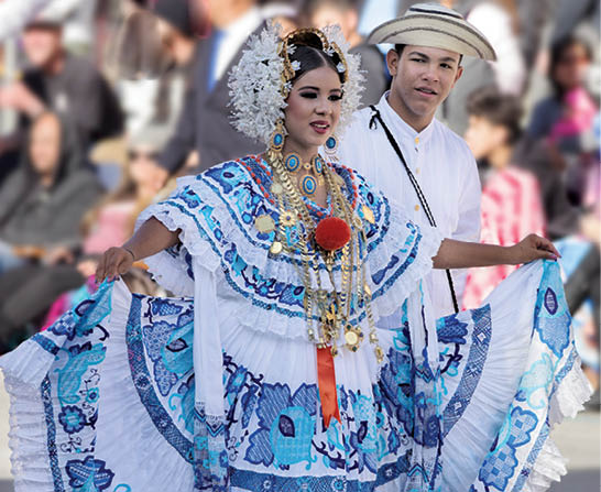 Young Panamanian couple dancing during the Tournament of Roses in Pasadena. The woman is wearing a traditional Panamanian folklore dress or 'Pollera' and jewelry.