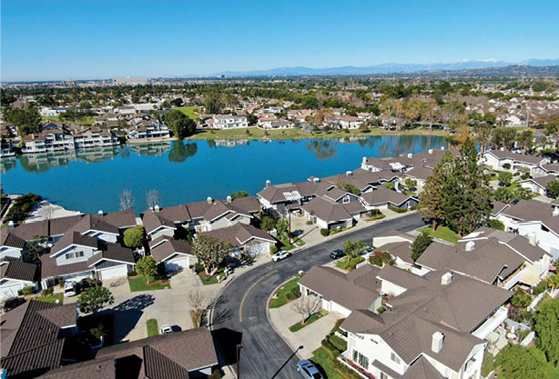 Aerial view of North Lake surrounded by residential neighborhood during blue sky day in Irvine, Orange County, USA