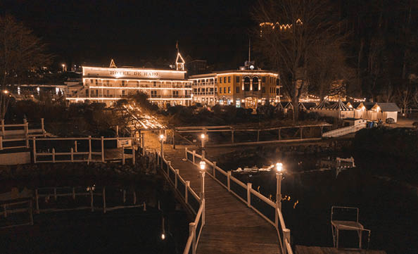 A pier with a wooden walkway and lights. Description generated by AI