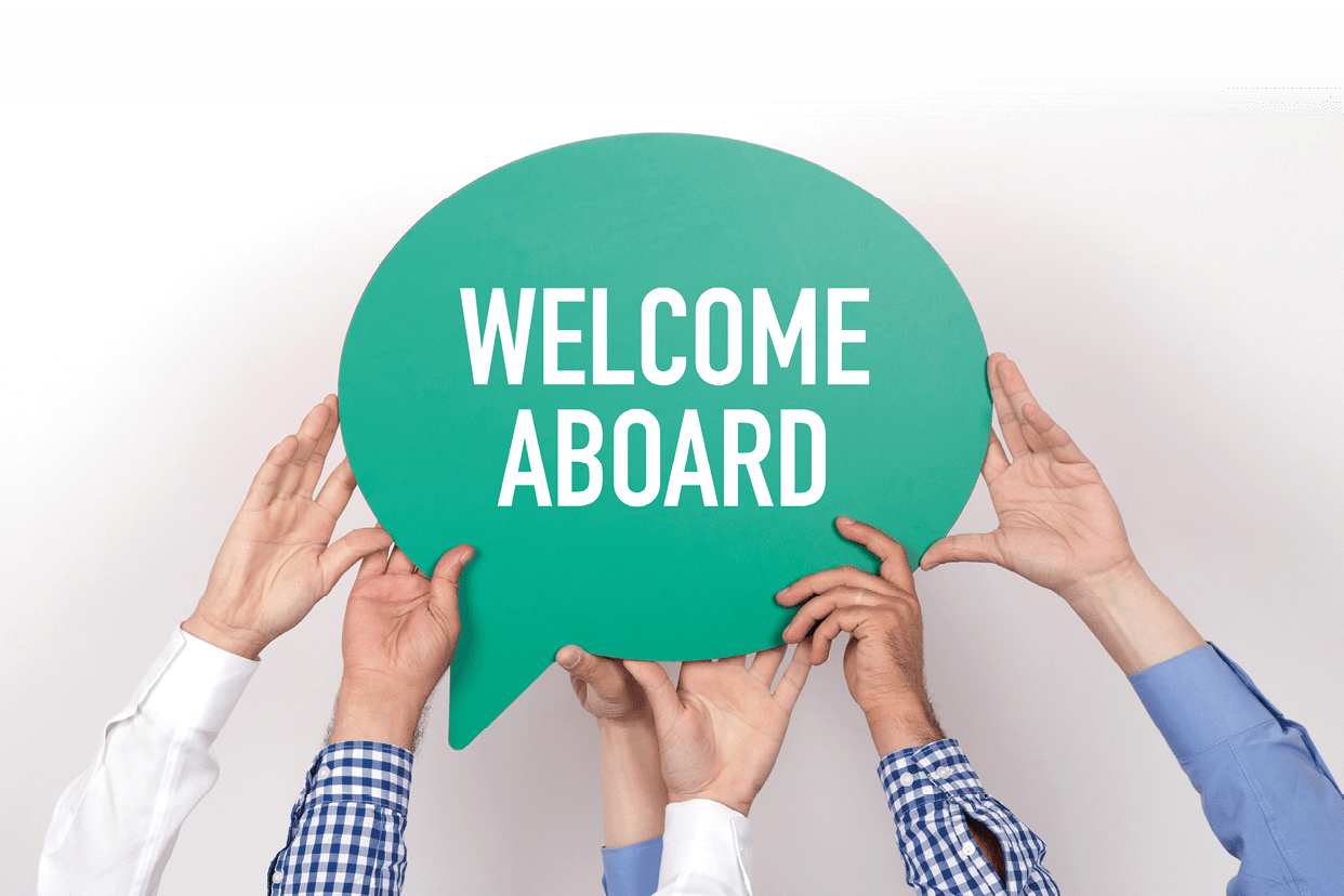 Group of people holding the WELCOME ABOARD written speech bubble