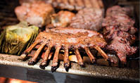 Lambchop and roasting artichokes at the Hitching Post building with classic cars parked out front, located near Santa Maria Valley in Casmalia, California 