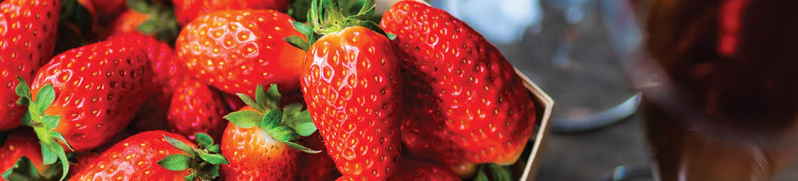 Pair of glass full of rose champagne with ripe strawberry as a party concept