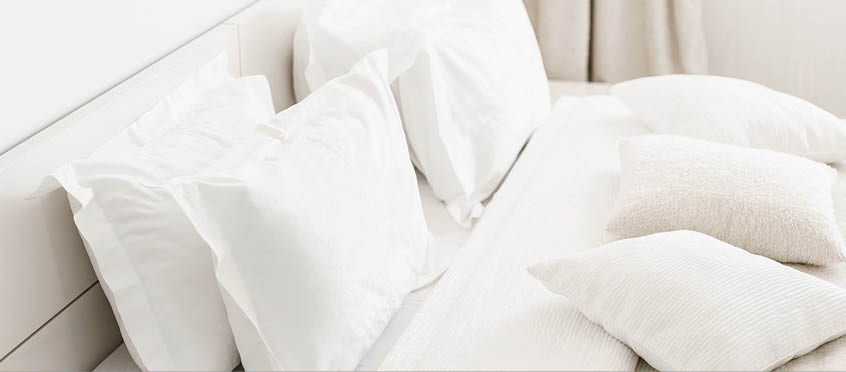 Modern double bedroom  Comfortable soft white pillows on a bed  Inside rooms of a apartment or hotel
