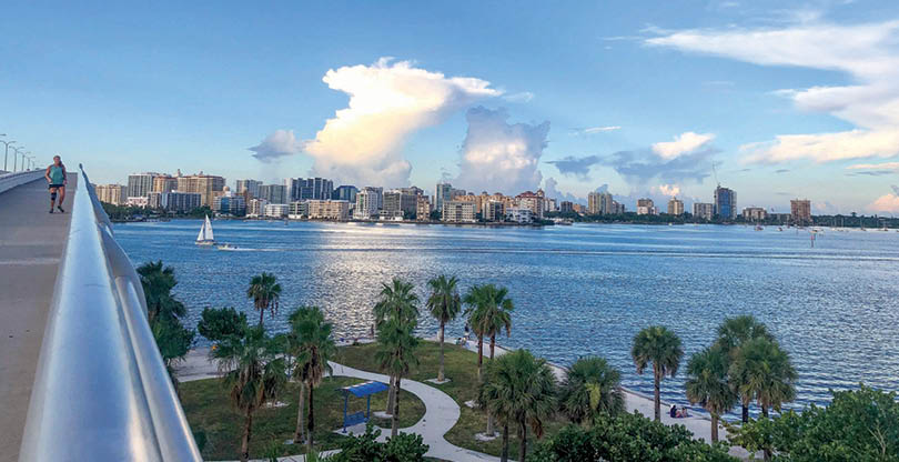 Girl runs over Ringling Bridge toward downtown Sarasota