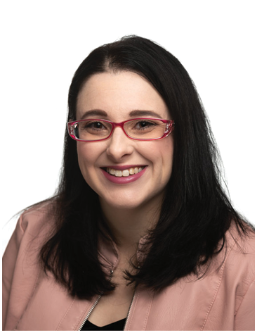 A woman wearing glasses and a pink jacket smiles for the camera. AI generated content