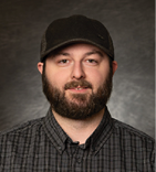 A man wearing a hat and a plaid shirt. AI generated content