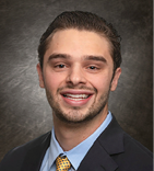 A man wearing a suit and tie smiles for the camera. AI generated content