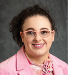 A woman wearing a pink jacket and pink shirt with a pink bow tie. AI generated content