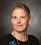 A woman wearing a black shirt and a blue pin. AI generated content