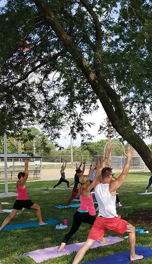 A group of people are practicing yoga in a park. AI generated content