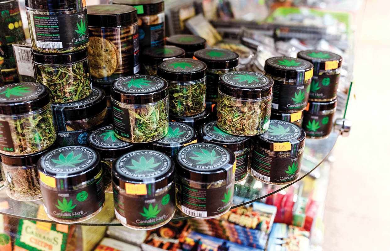 07 December 2017, Prague, Czech Republic: Sale of cannabis and other herbs in jars as a souvenir in the store