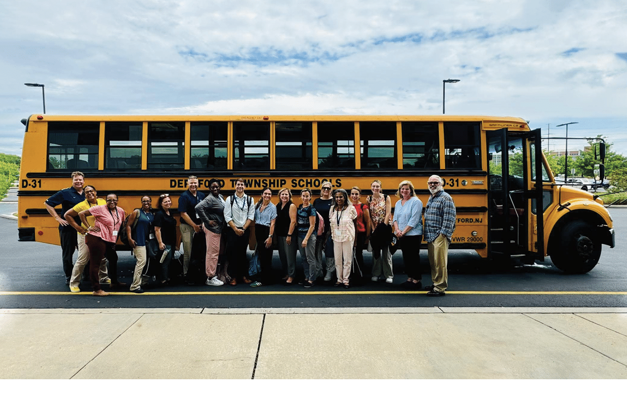 A group of people pose in front of a yellow school bus. AI generated content
