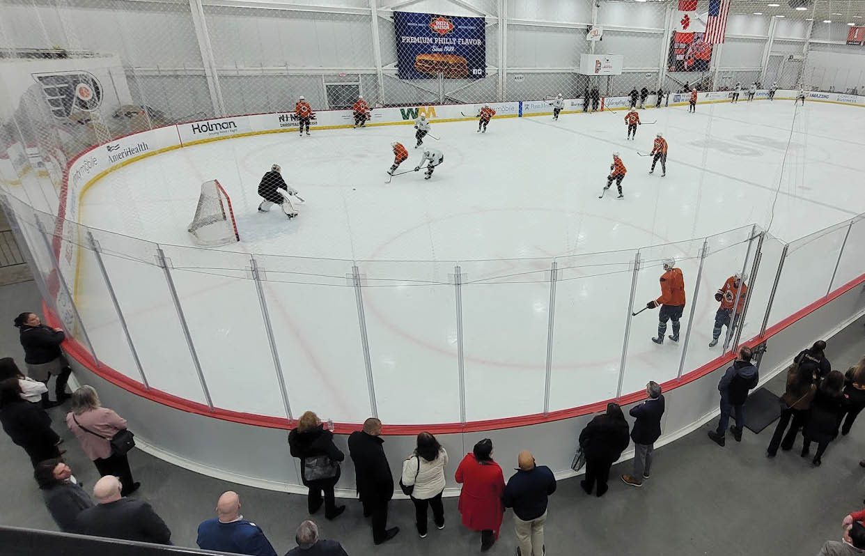 A group of people are watching a hockey game in an arena. AI generated content