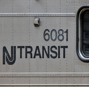 Hoboken, NJ - Aug 3, 2024: NJT New Jersey Transit logo next to window on a commuter train car numbered 6081.