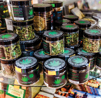 07 December 2017, Prague, Czech Republic: Sale of cannabis and other herbs in jars as a souvenir in the store