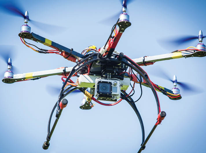 Remote drone flying with video camera on board.