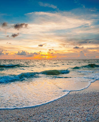 Marco Island in Florida has beautiful sunsets. The waters of the Gulf of Mexico roll in over seashells deposited on the beach.